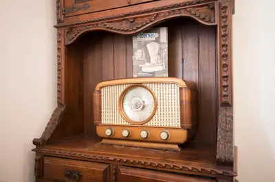 an old clock sitting on top of a wooden cabinet at As Viñas in Viveiro