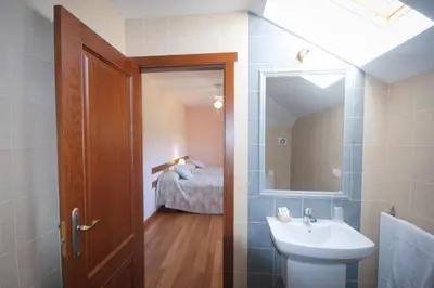 a bathroom with a sink and a mirror at As Viñas in Viveiro