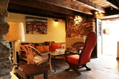 a living room with a couch and a table at Rural Médulas Viviendas de uso turistico 2 y Casas rurales 2 in Las Médulas