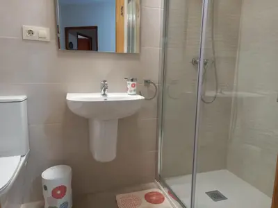 a bathroom with a sink and a shower at Albergue Agarimo in Caldas de Reis