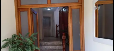 a hallway with a glass door with a potted plant at Albergue Agarimo in Caldas de Reis