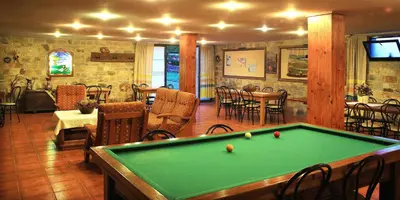 a billiard room with a pool table in a restaurant at Alojamiento en entorno rural Los Trobos in Villar de Otero