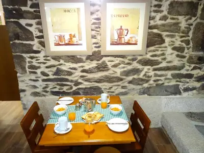 a wooden table with food on it with pictures on the wall at LAST 12K in Santiago de Compostela