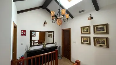 a hallway with a mirror on the wall and a staircase at LAST 12K in Santiago de Compostela