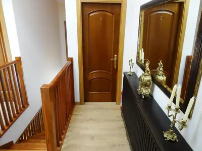 a hallway with two wooden doors and a staircase at LAST 12K in Santiago de Compostela