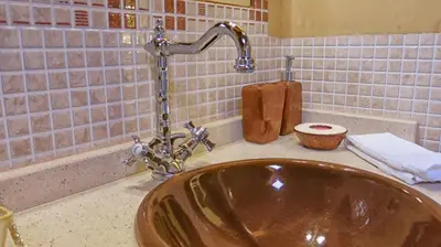 a sink with a faucet in a bathroom at Hotel Valle del Silencio in Ponferrada