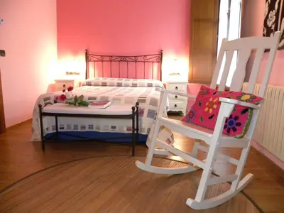 a bedroom with a bunk bed and a chair at Hotel Valle del Silencio in Ponferrada