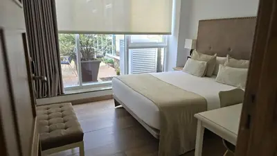 a bedroom with a large bed and a window at VISTALEGRE Hotel-Spa in Portomarin