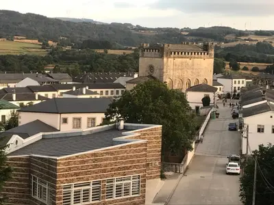 a view of a town with a building and a street at Pensión Portomiño in Portomarin