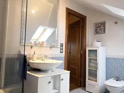 a bathroom with a sink and a toilet at Apartamento Apega in Ribadeo