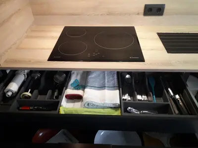 a drawer in a kitchen with a stove in it at Besbello Suites - Apartamento in Santiago de Compostela