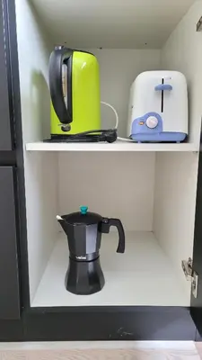 a coffee pot and a toaster sitting on a shelf at Besbello Suites - Apartamento in Santiago de Compostela
