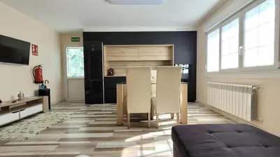 a living room with a couch and a table at Besbello Suites - Apartamento in Santiago de Compostela