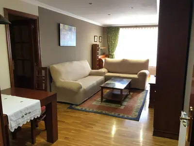 a living room with a couch and a table at El piso de Carlos in Ribadeo