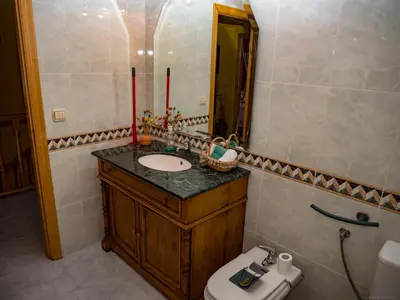 a bathroom with a sink and a toilet and a mirror at Casa rural quiroga in Portela