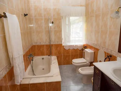 a bathroom with a tub and a toilet and a sink at Casa rural quiroga in Portela