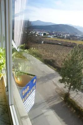 a sign in a window with a view of a street at Hotel Novo in Ponferrada