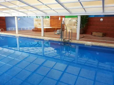 a large swimming pool in a building at Duplex Tres Dormitorios Playa A Rapadoira in Foz