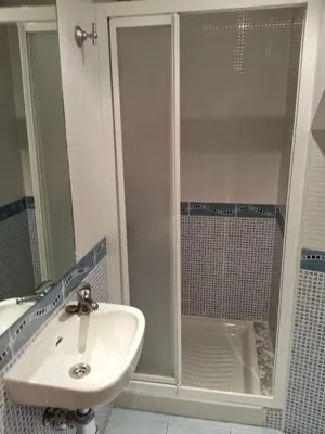 a bathroom with a sink and a shower at Duplex Tres Dormitorios Playa A Rapadoira in Foz