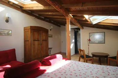 a bedroom with a bed with red pillows on it at Pazo de Chaioso Ribeira Sacra in Maceda