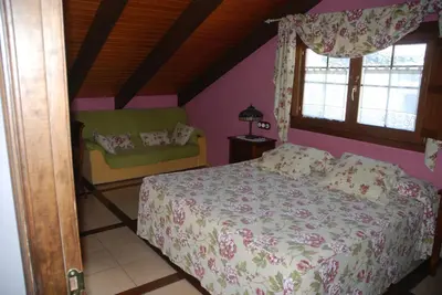 a bedroom with a bed and a couch at Lugar do Sixto in Cordido