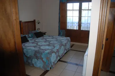 a bedroom with a bed and a window and a door at Lugar do Sixto in Cordido