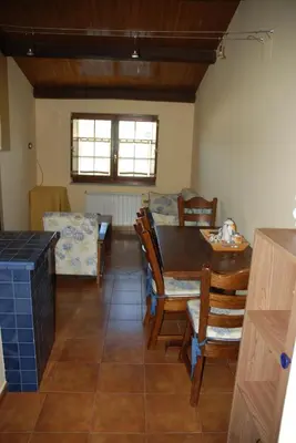 a dining room with a table and chairs at Lugar do Sixto in Cordido