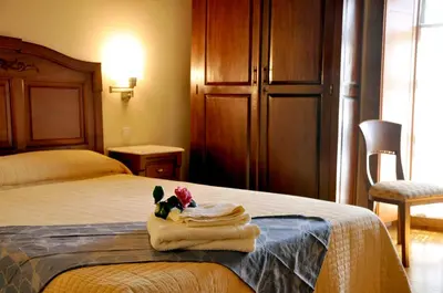 a hotel room with a bed with a towel on it at PR San Nicolás in Santiago de Compostela