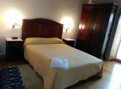 a bedroom with a large bed and two night stands at PR San Nicolás in Santiago de Compostela