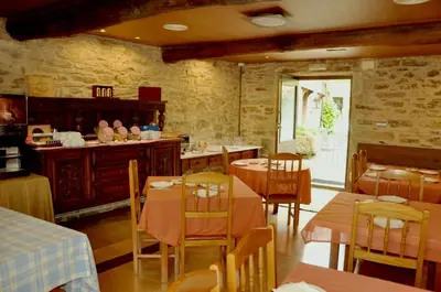 a restaurant with tables and chairs in a room at PR San Nicolás in Santiago de Compostela