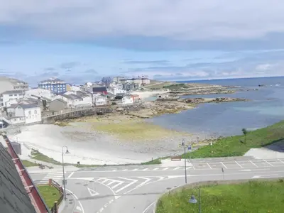 a view of a beach with houses and the ocean at San Ciprian Atico Tres Playas by I Love Norte in San Ciprián