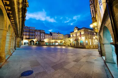 an empty street in a city at night at Luminoso Termal Casco Histórico in Ourense