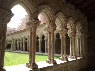 a view of the arcade of a building with columns at Luminoso Termal Casco Histórico in Ourense