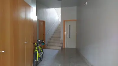 a bike parked in a hallway with a staircase at Luminoso Termal Casco Histórico in Ourense