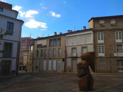 a statue of a head in the middle of a street at Luminoso Termal Casco Histórico in Ourense