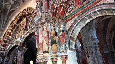 a church with a bunch of paintings on the wall at Luminoso Termal Casco Histórico in Ourense