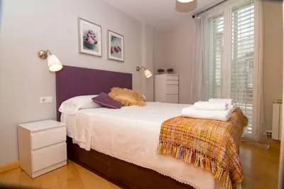 a bedroom with a bed with towels on it at Luminoso Termal Casco Histórico in Ourense