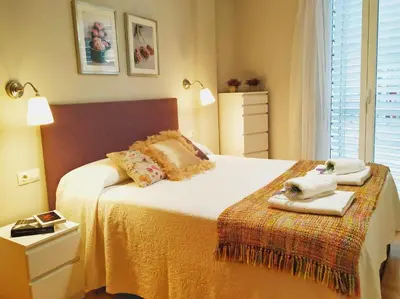 a bedroom with a bed with towels on it at Luminoso Termal Casco Histórico in Ourense