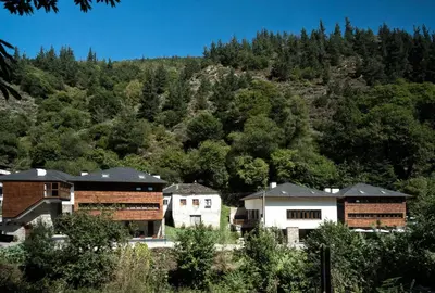 a group of buildings in front of a mountain at Hotel Rural Las Montañas de Pumar in Besullo