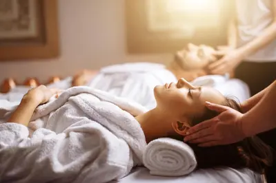 a woman laying on a bed getting a massage at Hotel Rural Las Montañas de Pumar in Besullo