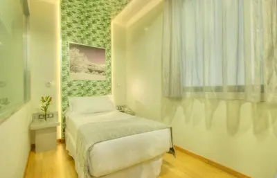 a small bedroom with a bed and a window at NH Ourense in Ourense