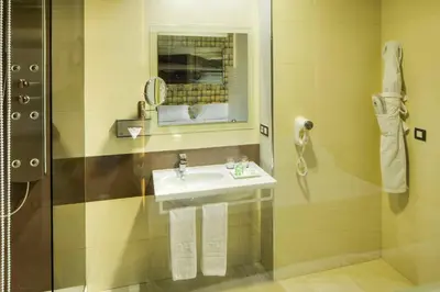 a bathroom with a sink and a shower at NH Ourense in Ourense
