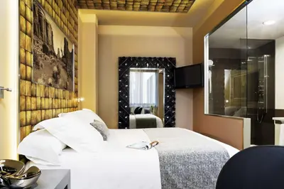 a bedroom with a white bed and a mirror at NH Ourense in Ourense