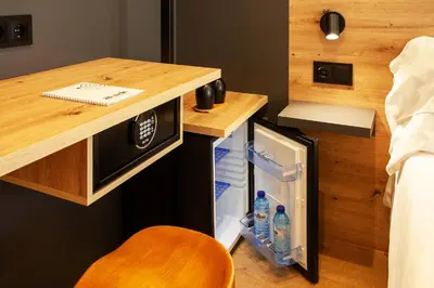 a small kitchen with a desk and a refrigerator at Plaza Obradoiro Express by Bossh! Hotels in Santiago de Compostela