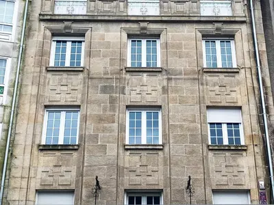 a tall brick building with many windows at Plaza Obradoiro Express by Bossh! Hotels in Santiago de Compostela