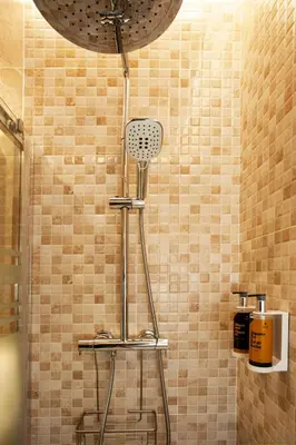 a shower in a bathroom with a shower head at Plaza Obradoiro Express by Bossh! Hotels in Santiago de Compostela