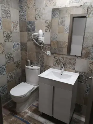 a bathroom with a toilet and a sink and a mirror at Monqar Playa Foz in Foz
