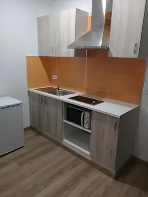 a kitchen with a sink and a stove top oven at Monqar Playa Foz in Foz