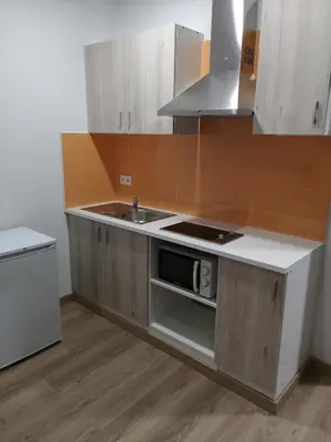 a kitchen with a sink and a stove top oven at Monqar Playa Foz in Foz