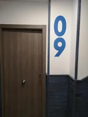 a door with the number eight next to a wall at Monqar Playa Foz in Foz